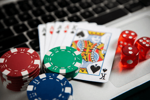 deck of cards with casino chips and dices